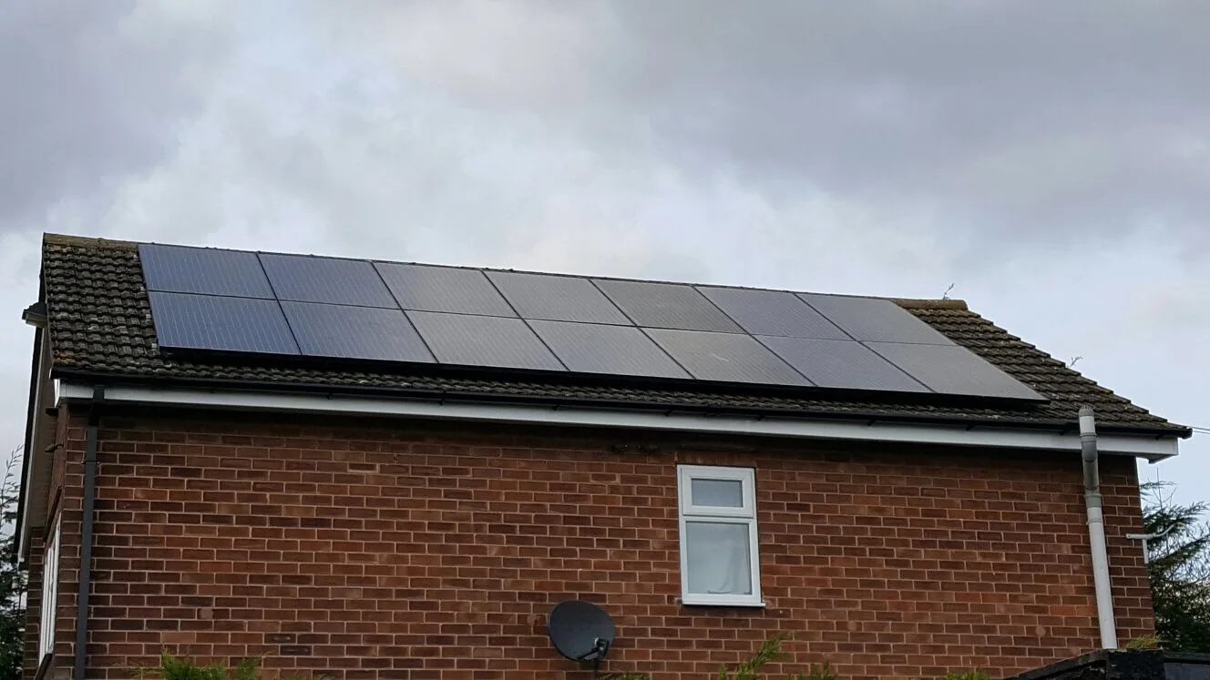 Completed solar array on the roof of a red-brick house