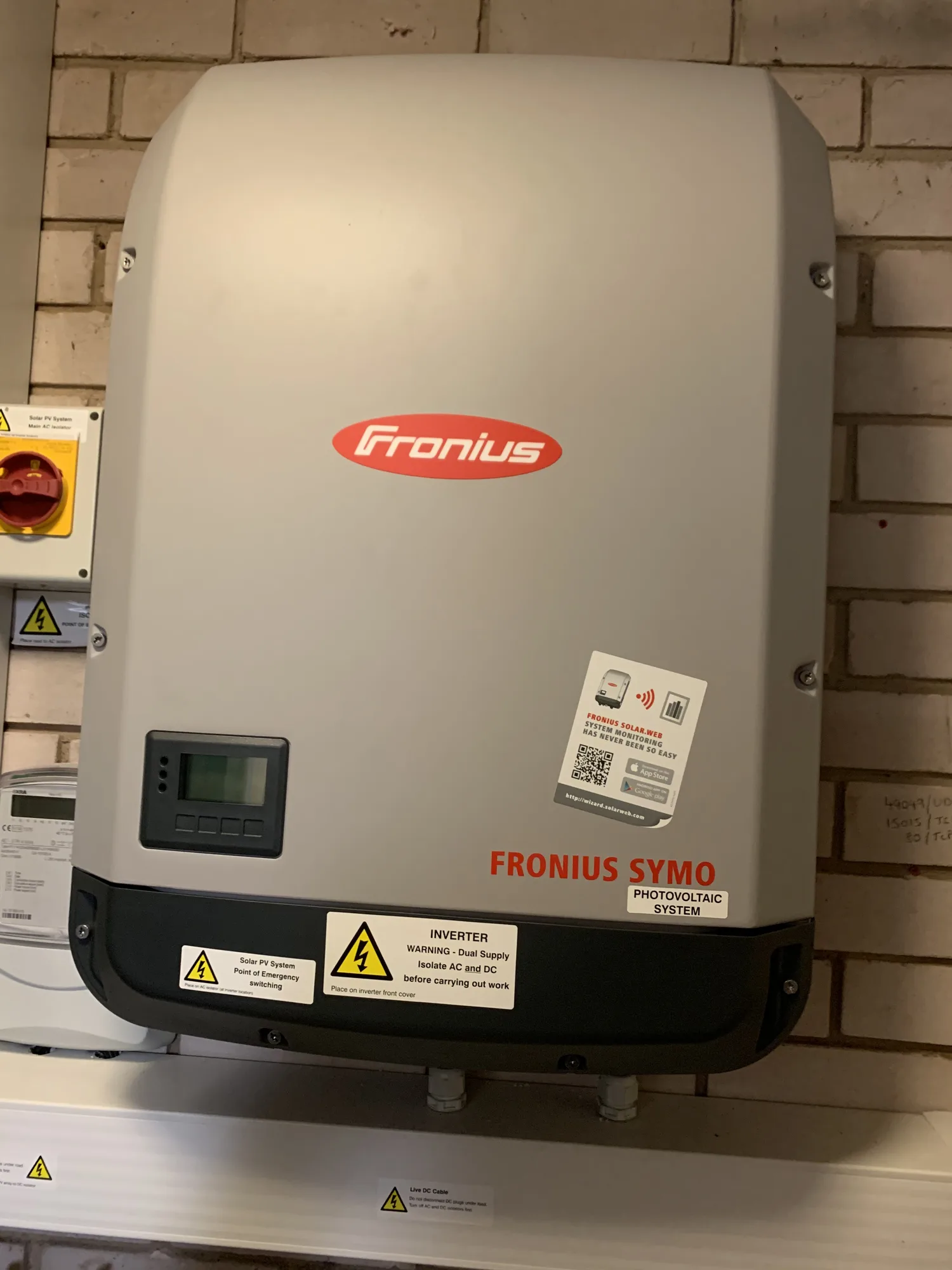 Fronius solar inverter mounted on a garage wall