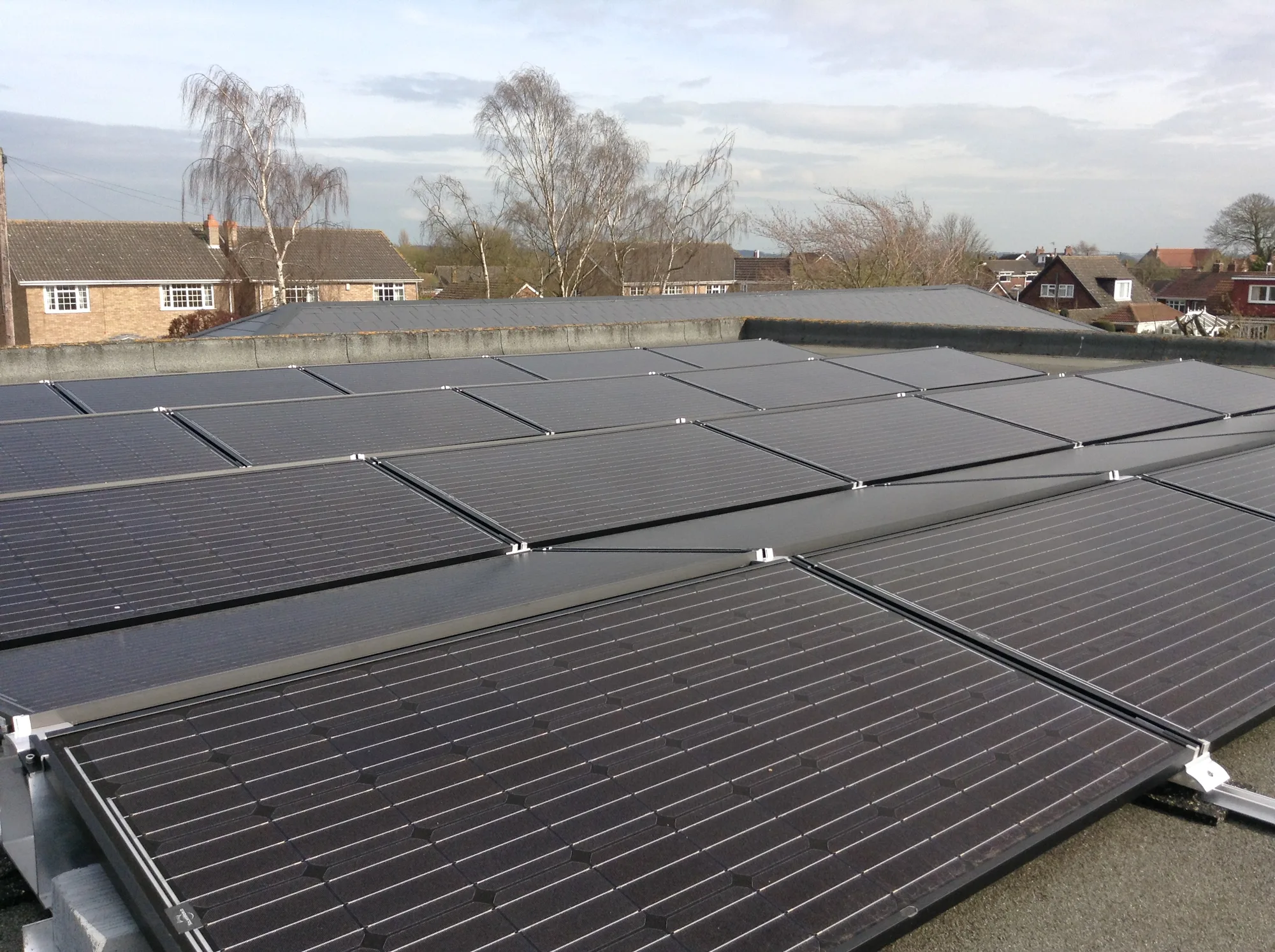 Rows of solar panels on a flat-roof installation