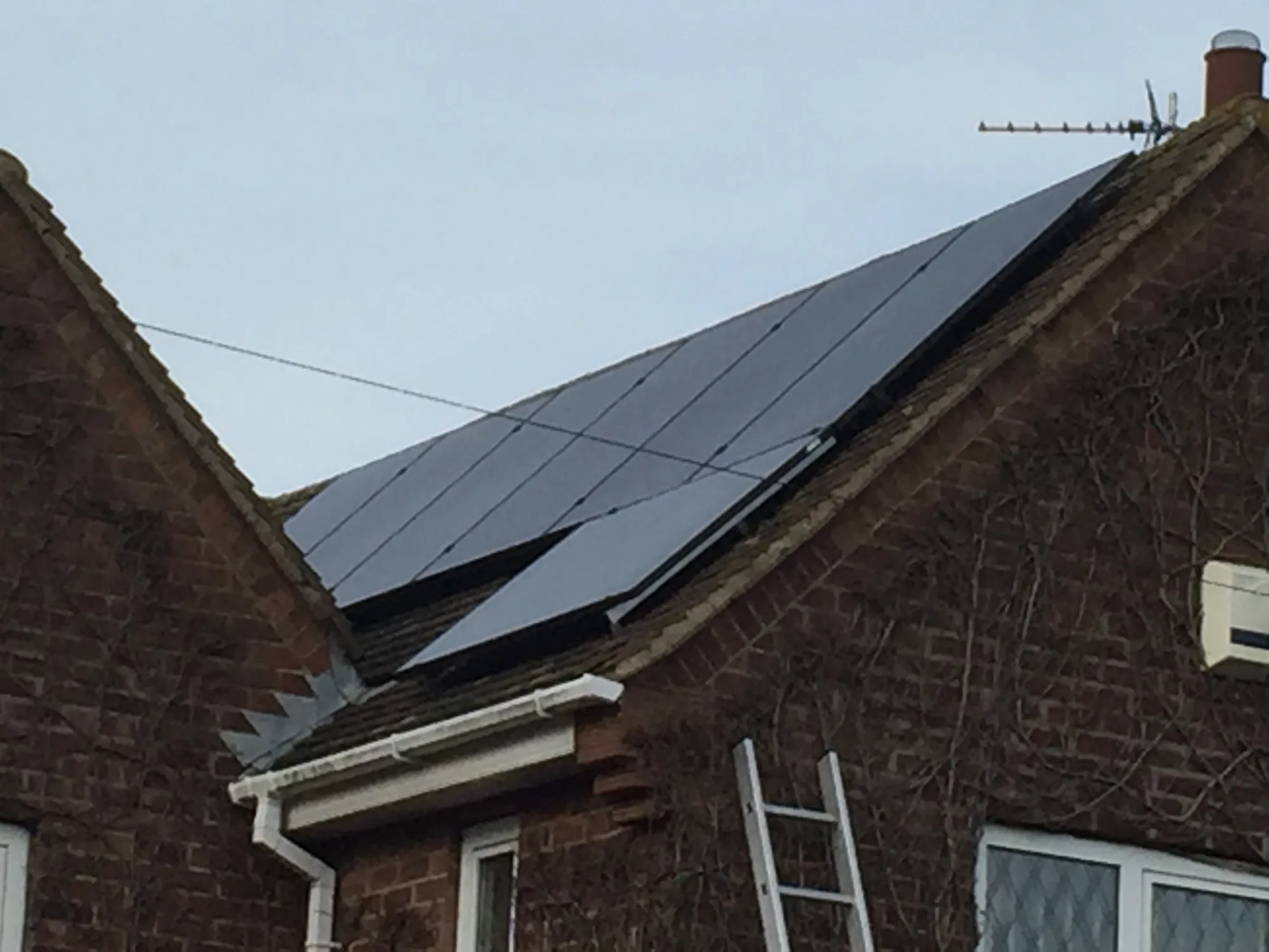 Solar array fitted to the pitched roof of a brick property