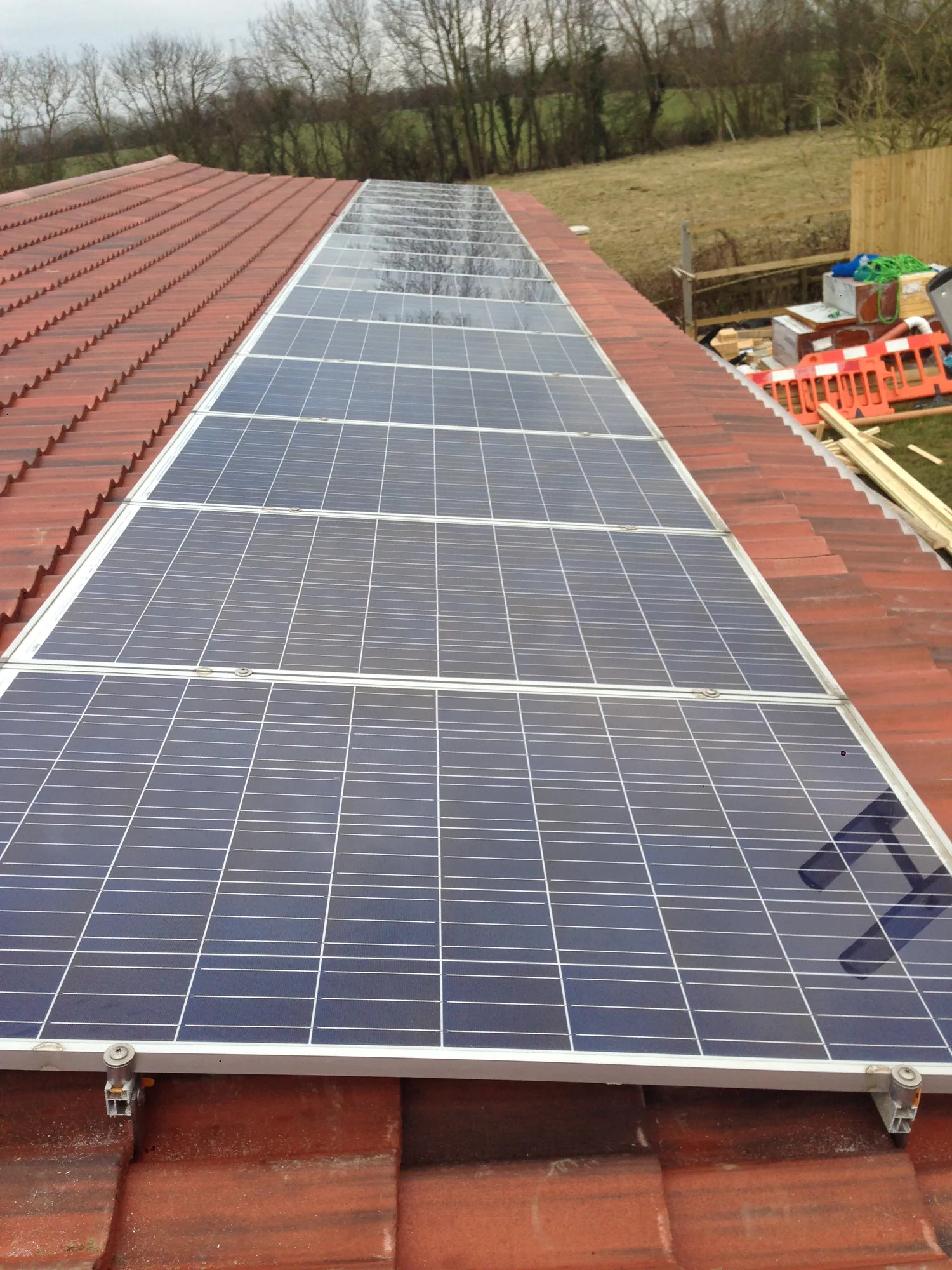 Full-length solar array running along a tiled roof
